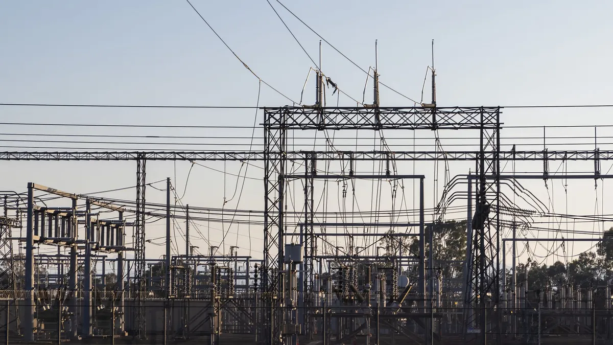 Tecnici davanti a una sottostazione elettrica ad alta tensione